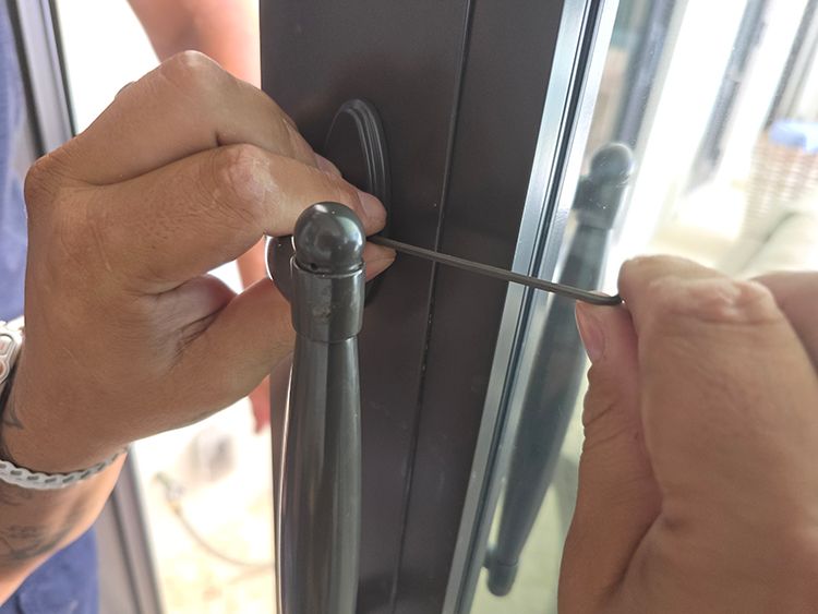 Technician adjusting a sliding door handle