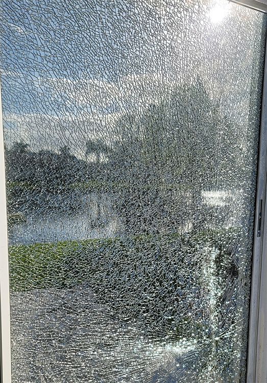 Cracked sliding glass door glass after a storm