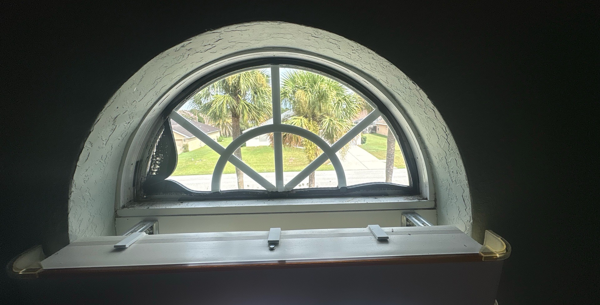 Insulated glass unit being removed from an arched picture window